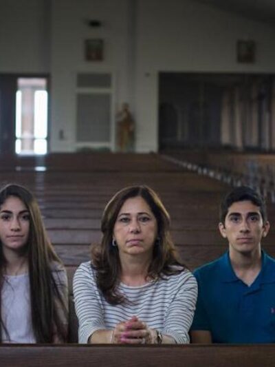 Portrait of the Hamama Family sitting in a pew in a church