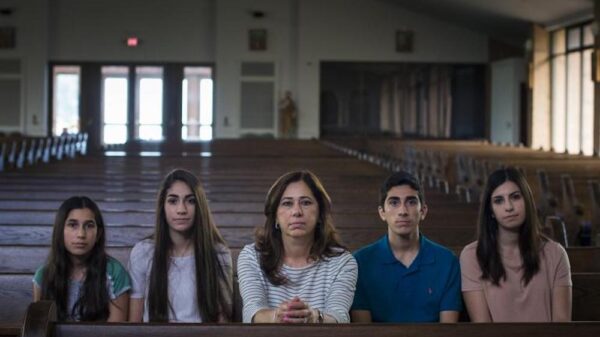 Portrait of the Hamama Family sitting in a pew in a church