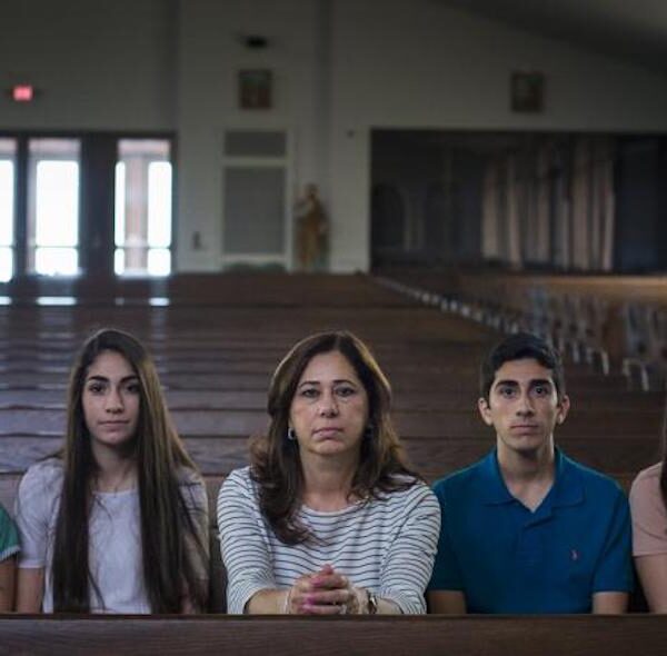 Portrait of the Hamama Family sitting in a pew in a church