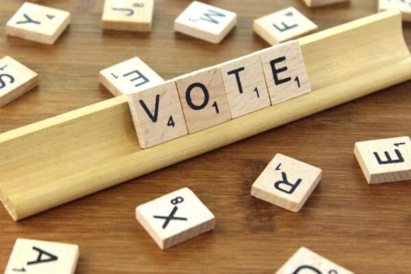 Scrabble tiles that read "Vote"