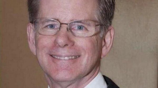 Judge Steven Rhodes wears wide-framed glasses and has salt and pepper hair. He smiles at the camera.