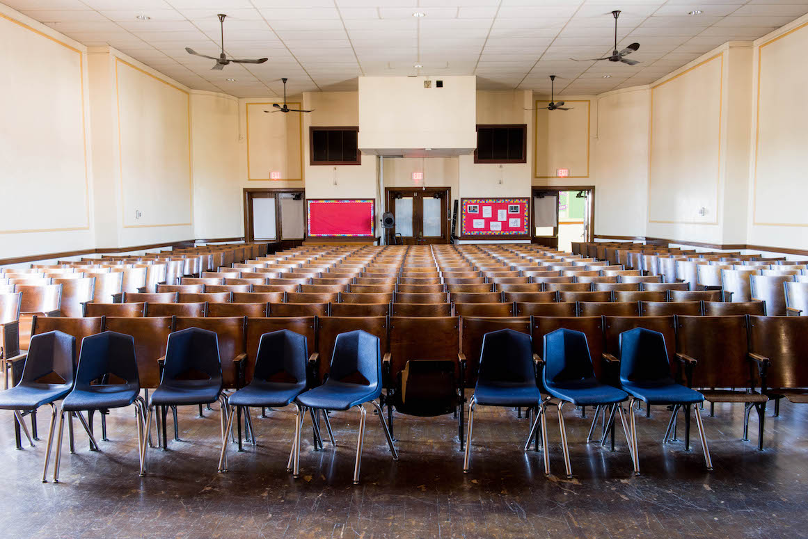 Teachers and administration at Kosciuszko Middle School take pride in the beauty of their building's auditorium. However, as the district lacks funding to make basic repairs, instead of antique wooden chairs, they have been supplemented with plastic ones