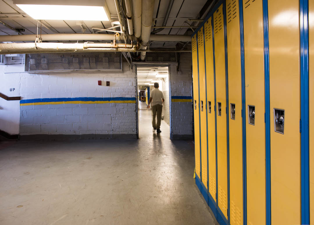 The hallway that connects Dickinson West Elementary School with Kosciuszko Middle School reveals the marks of decay characteristic of any under-maintained building without the proper funds to fix floor tiles and repaint surfaces.