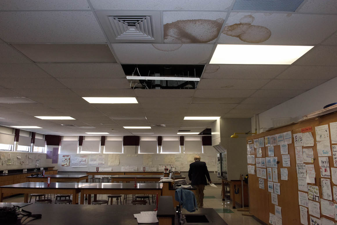 A science lab at Hamtramck High School is decorated proudly with student work, but marred by the scars of multiple roof leaks.