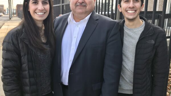 Sam Hamama standing with his daughter and son
