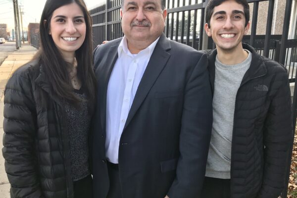 Sam Hamama standing with his daughter and son
