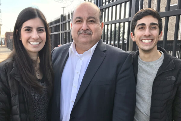 Sam, Brittany and Chris Hamama standing together in Detroit