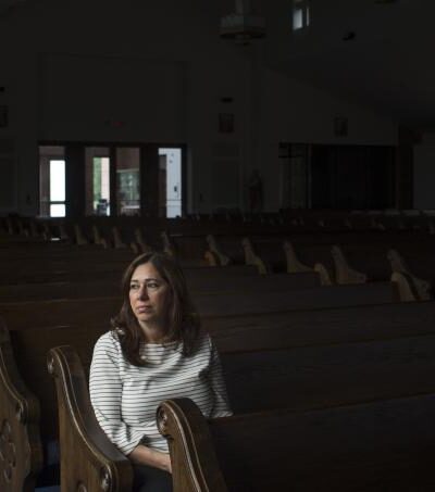 Nahrain Hamama seated alone in church pew