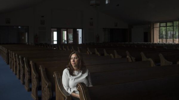 Nahrain Hamama seated alone in church pew