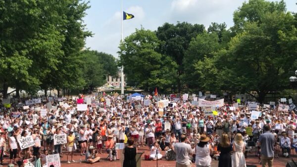 Protesters holding signs, wide shot in Ann Arbor