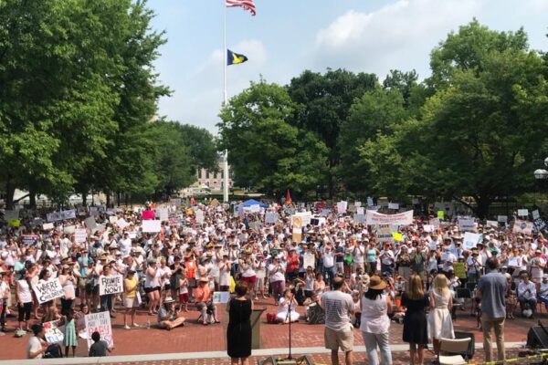 Protesters holding signs, wide shot in Ann Arbor