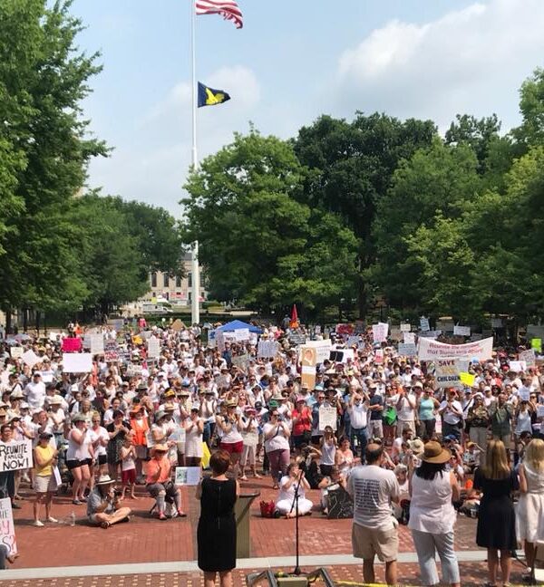 Protesters holding signs, wide shot in Ann Arbor