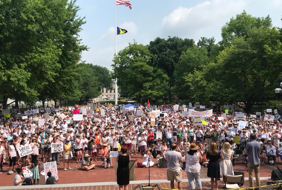 Protesters holding signs, wide shot in Ann Arbor