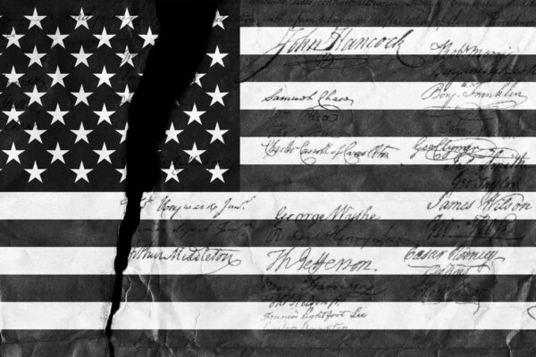 Graphic of black and white American flag with tear through it