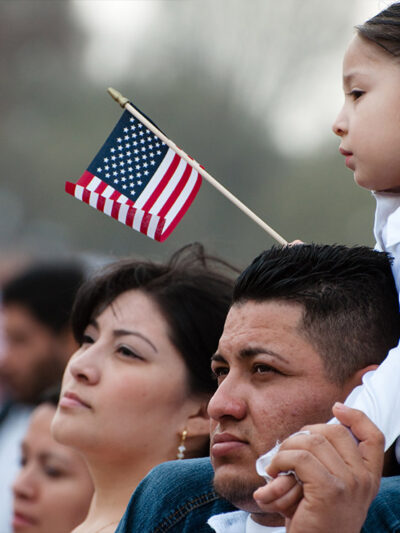 A girl and her father stand with some 200,000 immigrants' rights activists flood the National Mall to demand comprehensive immigration reform on March 21, 2010 in Washington DC.