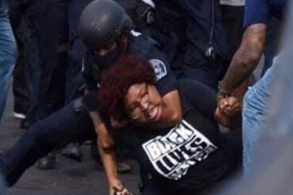 Protestor being handcuffed