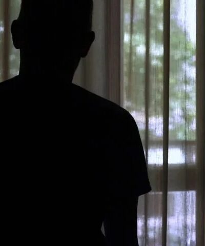 silhouette of anoymous person looking out window