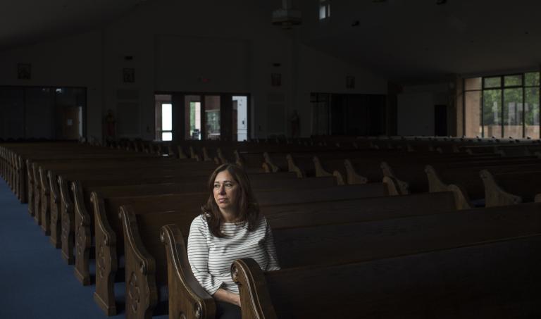 Nahrain Hamama seated alone in church pew