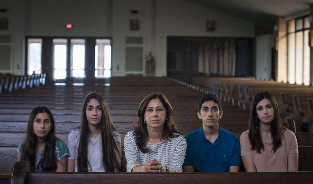 Portrait of the Hamama Family sitting in a pew in a church