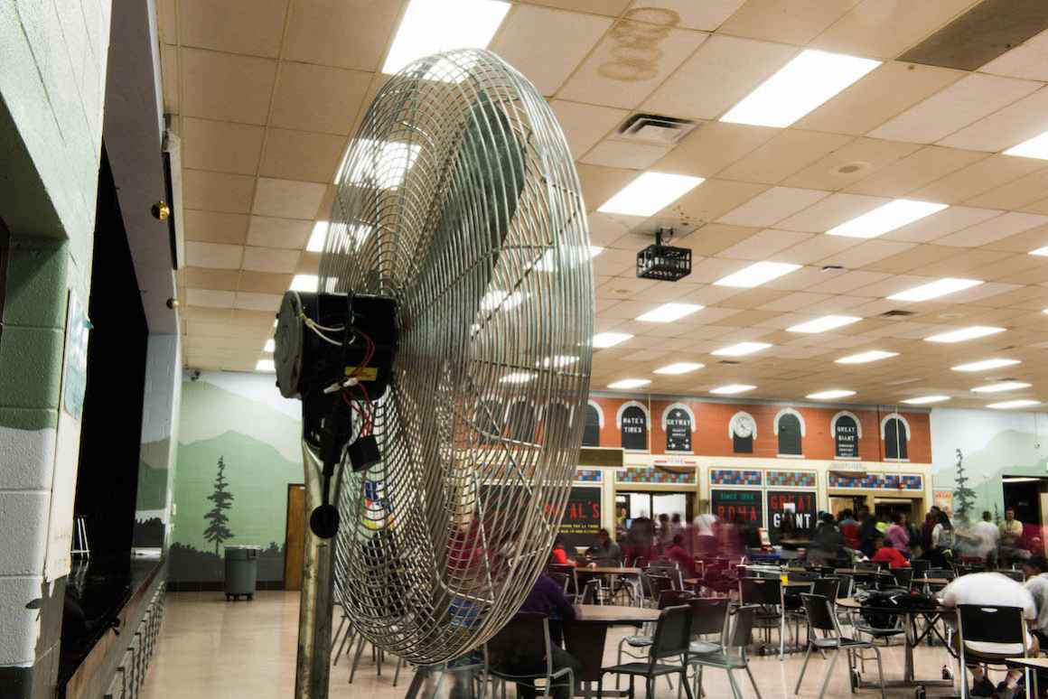 At Beecher High School, the lack of air conditioning requires staff to use large fans. With only a few fans, purchased from the school's general fund, staff must move these fans around, depending on where students are in any given moment. 