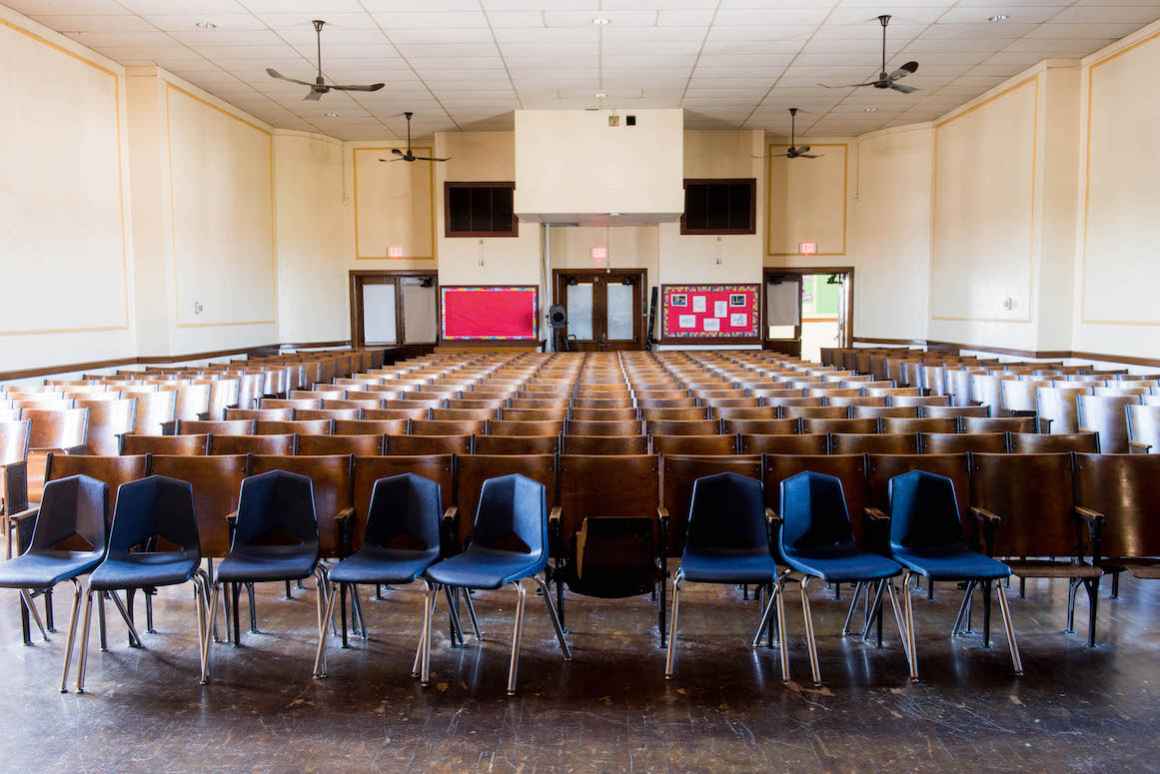 Teachers and administration at Kosciuszko Middle School take pride in the beauty of their building's auditorium. However, as the district lacks funding to make basic repairs, instead of antique wooden chairs, they have been supplemented with plastic ones 