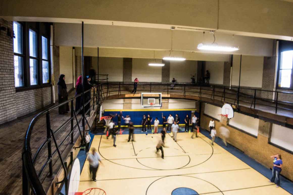 Elementary and middle-school students at the Hamtramck school building shared by the Dickinson West and Koscuizko schools play inside a small, aging gymnasium that was constructed in 1919.