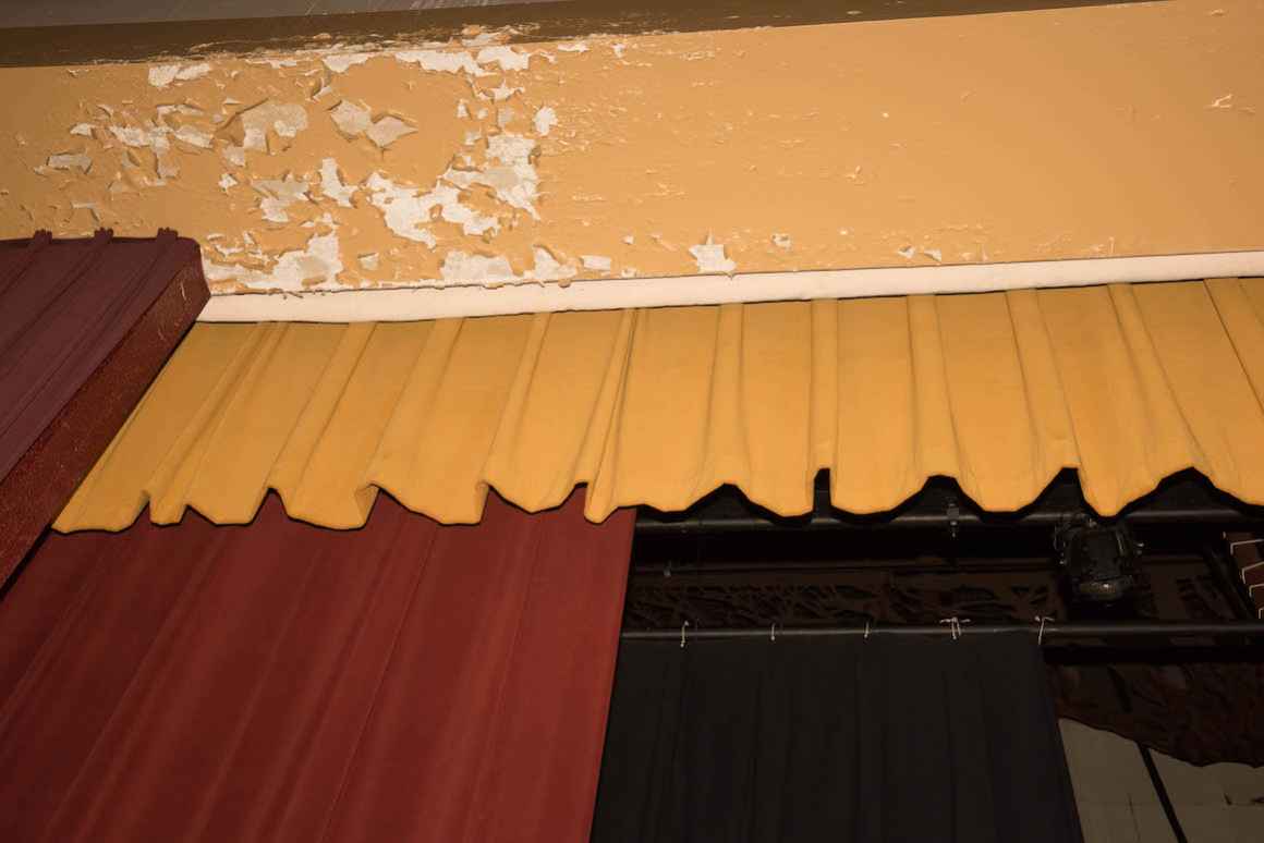 Plaster flakes off of the walls inside the 1960s-era auditorium at Muskegon High School.