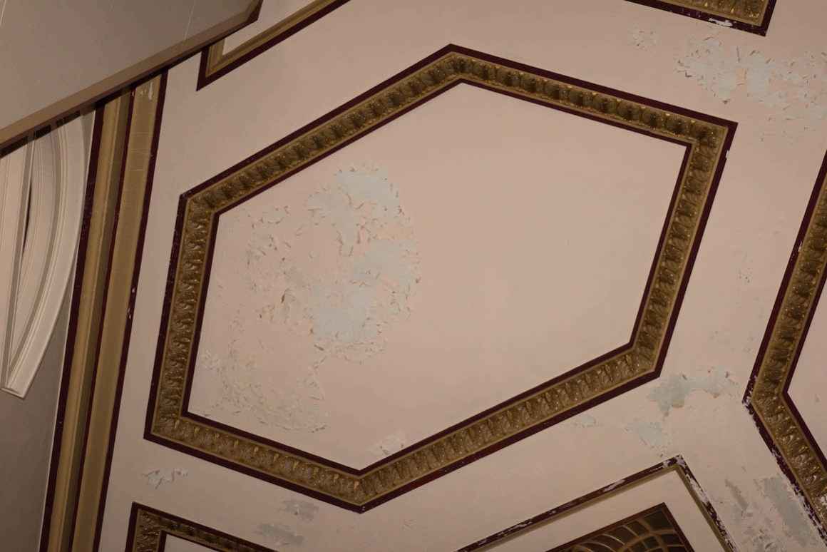 Plaster peels and flakes off of the walls of the 1960s-era auditorium at Muskegon High School. Plaster has not been replaced since the wing of the school was constructed.