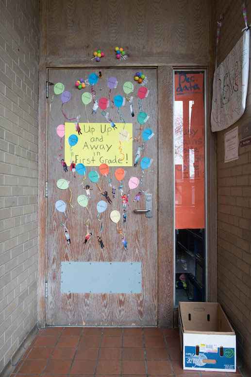  At Nelson Elementary School, decorations bearing children's names adorn old doors in need of refinishing.