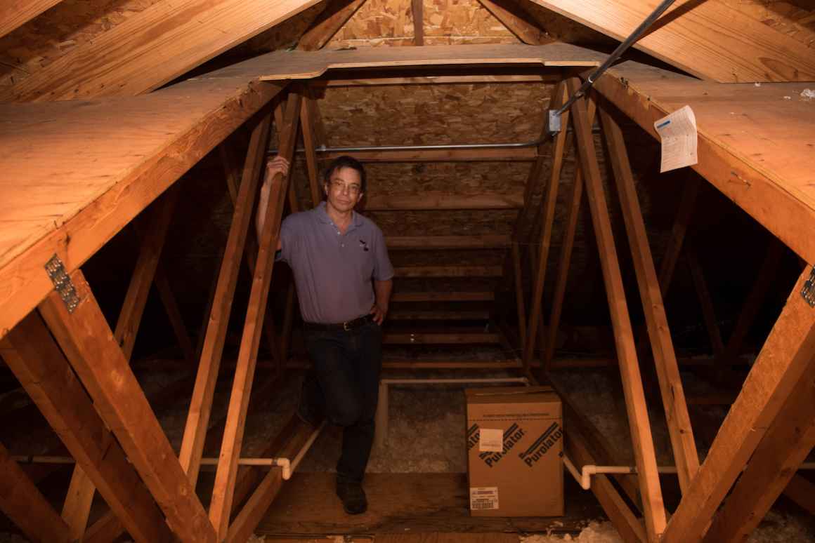 Andres Velez stands inside the Sodus school's new gabled roof. As principal, superintendent, maintenance director and lunchroom supervisor in the Sodus district, Velez wears multiple hats.