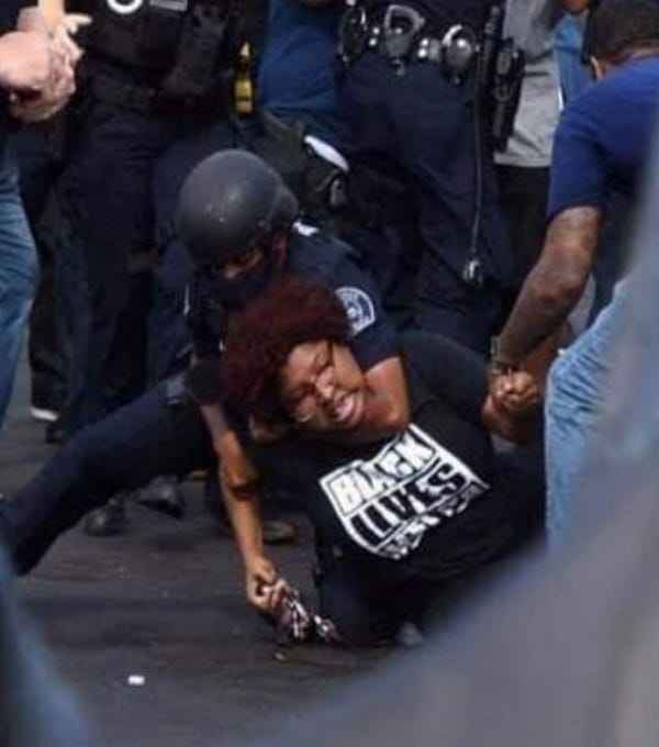 Protestor being handcuffed