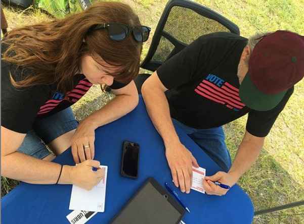 people signing up to volunteer for petition drives