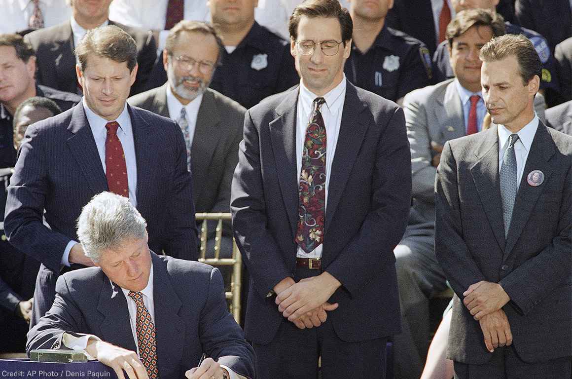 President Bill Clinton signs the $30 billion crime bill during a ceremony on the South Lawn of the White House in Washington on Sept. 13, 1994