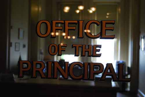 A glass door that says Office of the Principle