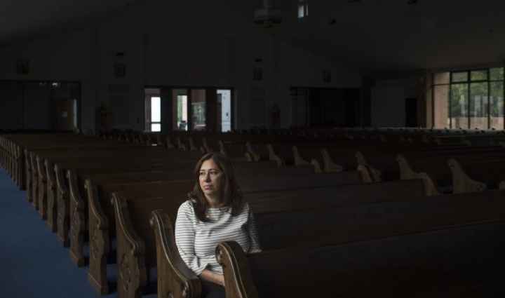 Nahrain Hamama seated alone in church pew