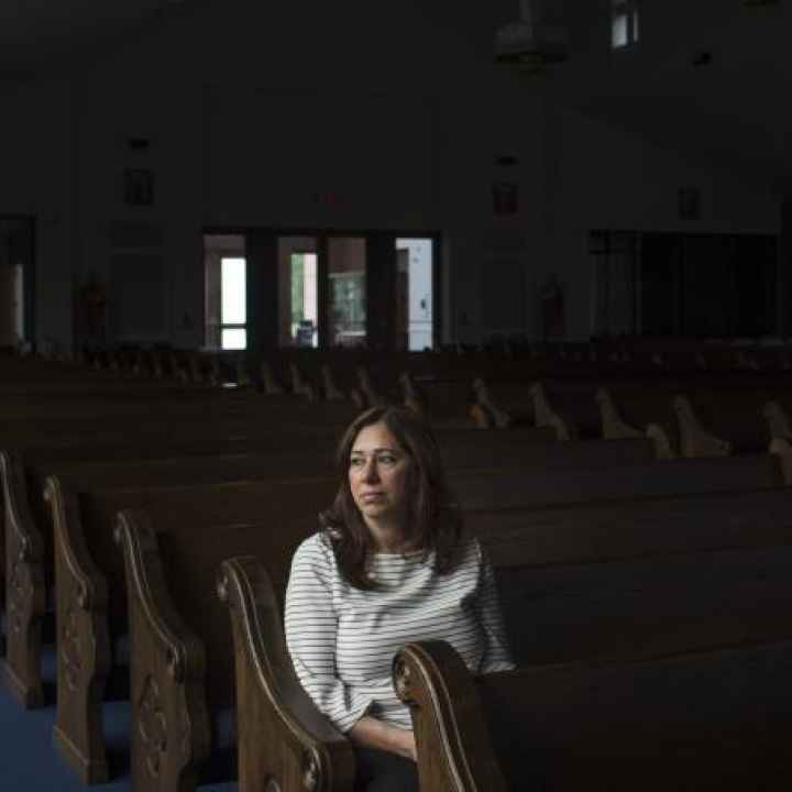 Nahrain Hamama seated alone in church pew