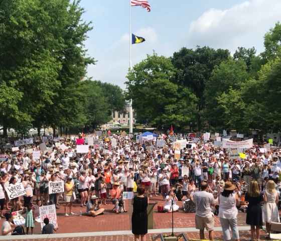 Protesters holding signs, wide shot in Ann Arbor